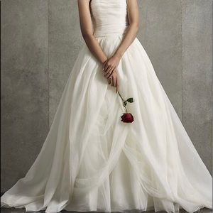 Cream colored, strapless wedding gown. Ball gown, very Princess-like.